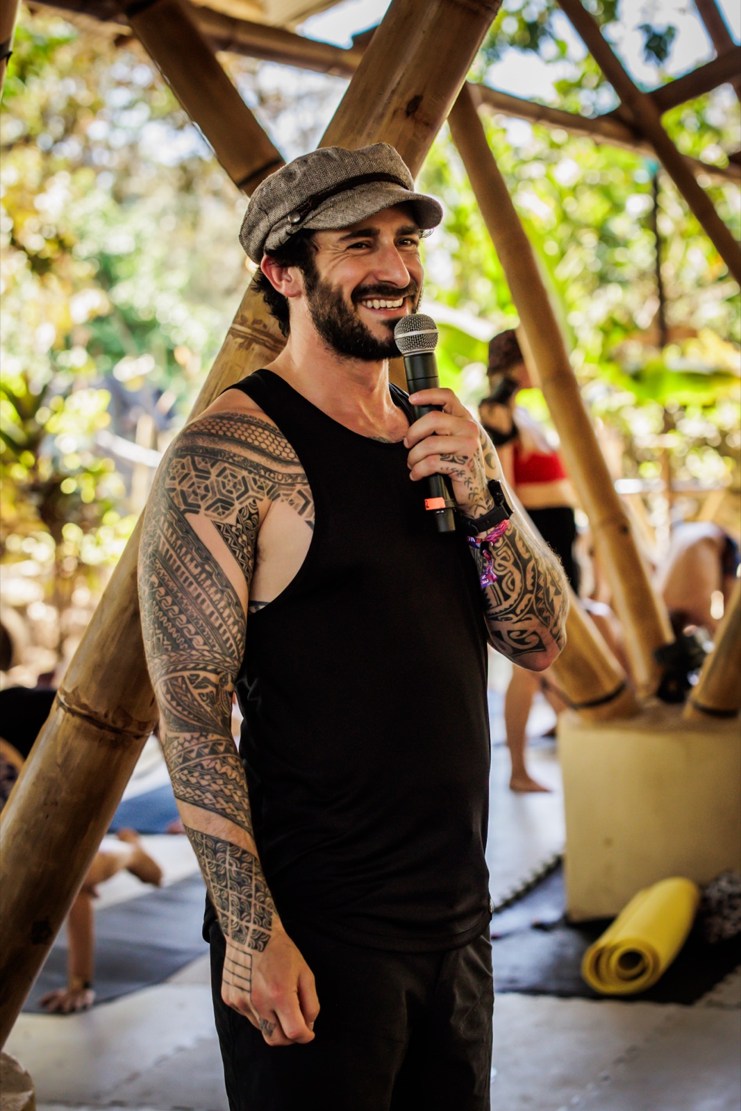 Peter teaching at Templo Estrella with a microphone, hands raised.