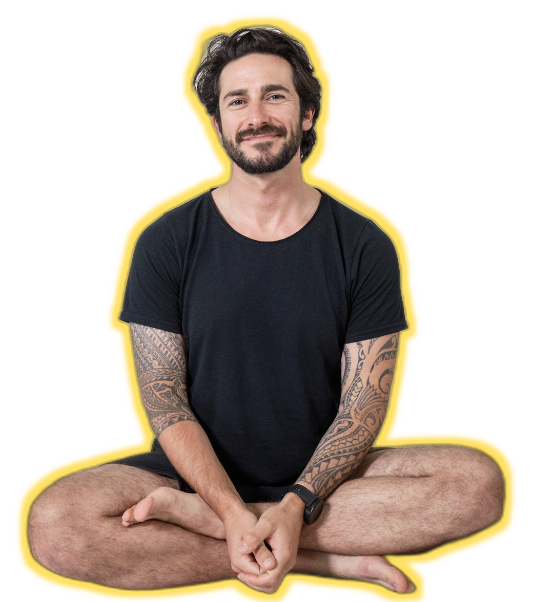 Peter Walters seated cross-legged, smiling at camera